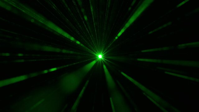 The laser pointer shining in darkness with a green light. slow motion