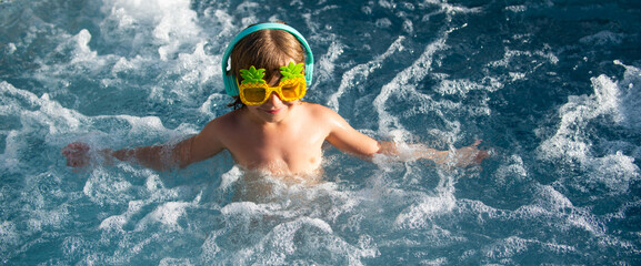 Boy swimming and playing in a pool.