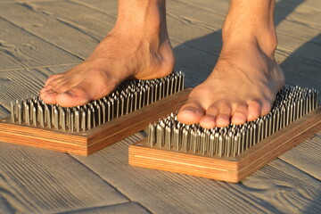 male feet on sadhu board