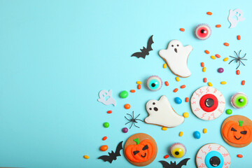 Fototapeta na wymiar Halloween sweets on colored background close up top view with place for text