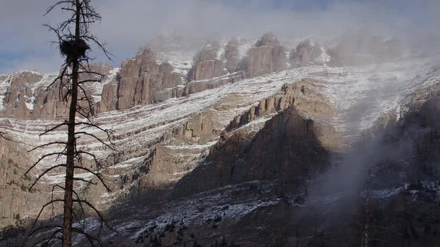 Foggy clouds moving over Hayden Peak as sun melts the snow after early Fall snow storm in the Uinta Mountains.