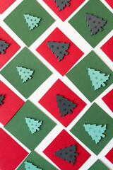 Fototapeta na wymiar wooden christmas tree shapes or silhouettes arranged on paper squares