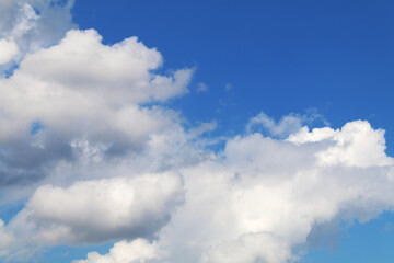 Naklejka na ściany i meble big puffy fluffy cumulus clouds cloudscape cloud and bright blue sky