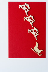wooden christmas reindeer and sled shapes or silhouettes arranged on paper