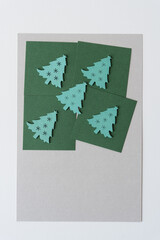 wooden christmas tree shapes or silhouettes arranged on paper squares