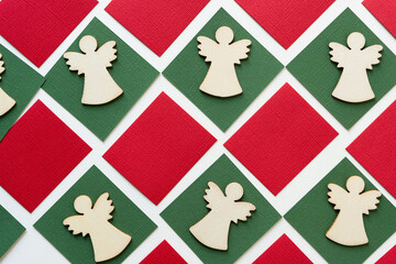 wooden christmas angel shapes or silhouettes arranged on paper squares