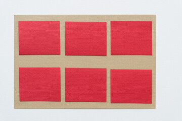 red paper squares on beige and white