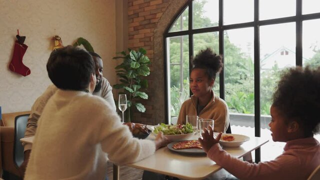 Happy African American family christmas dinner party. - Powered by Adobe