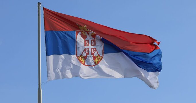 Serbian national flag on wind, outdoor
