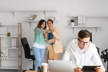 Women gossiping about their colleague in office
