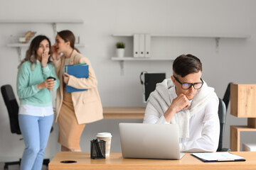 Women gossiping about their colleague in office