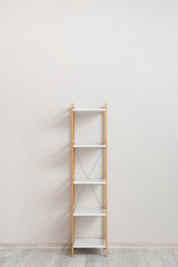 Stylish shelf unit near white wall