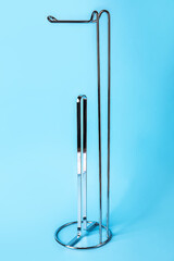 Empty toilet paper holder on blue background