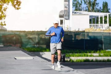 Sporty mature man running on stairs outdoors
