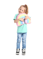 Funny little girl hugging toy rainbow on white background