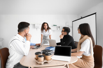 Fototapeta premium Young business colleagues working at table in office