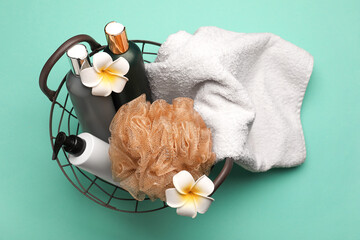 Basket with bath supplies on color background