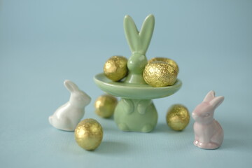 Easter time. Easter sweets.Spring religious holiday. Easter bunnies and golden chocolate eggs candy...