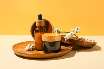 Composition with cosmetic products, flowers and honey on color background
