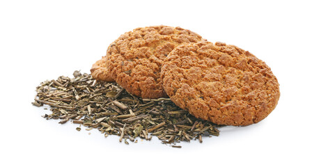Tasty hojicha cookies and dry leaves on white background