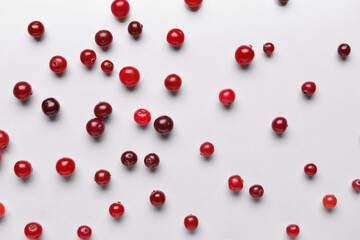 Tasty fresh cranberries on light background
