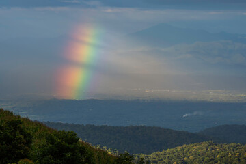 Rainbow over mountain meadow. Rainbow after the rain.
