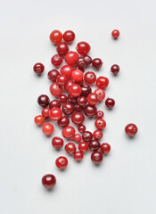 Tasty fresh cranberries on light background