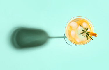 Glass with melon cocktail on color background