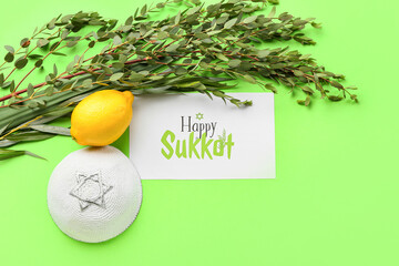Sukkot festival symbols and greeting card on color background