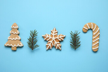 Winter composition with tasty cookies on blue background