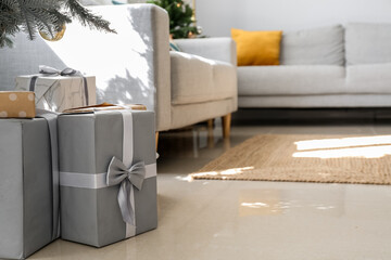 Gifts under Christmas tree on floor in living room