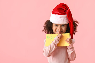 Cute African-American girl with letter to Santa on color background