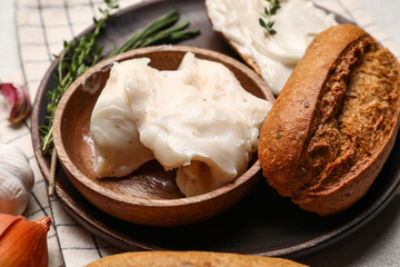 Bowl with lard spread and bread on table