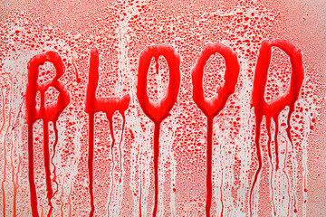 Word BLOOD and drops on light background
