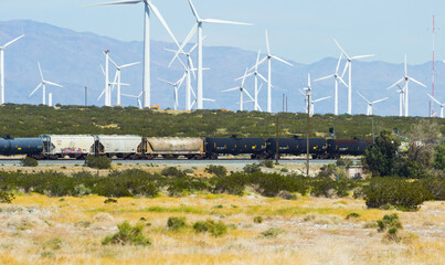 Fototapeta na wymiar Freight train and windmills