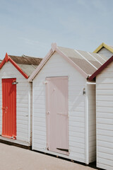 Fototapeta na wymiar Pastel beach huts by the beach