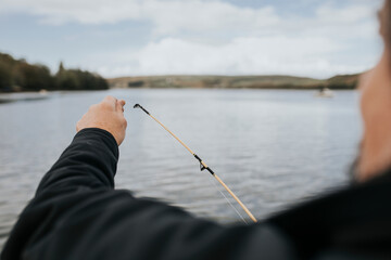 Senior man enjoying fishing by the lake