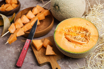 bowl of melon slices and slices on skewers.