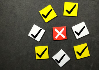 Colored cube with a correct sign and one incorrect sign. The concept of check marks