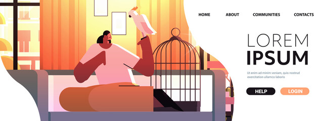 african american woman with parrot girl taking care of pet animal bird living room interior horizontal © mast3r