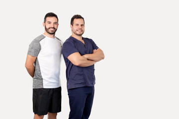 Two physiotherapists posing smiling with their arms crossed
