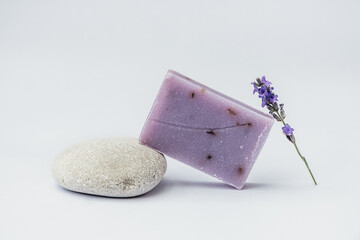 Lavender soap on the pedestal from sea stone on light background.