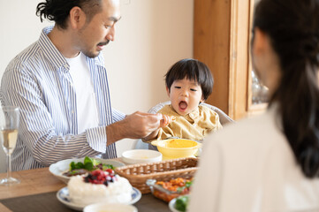 Image of a family dining table with a cute toddler who 