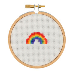 Rainbow cross stitch in an embroidery hoop on white background