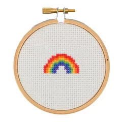 Fotobehang Rainbow cross stitch in an embroidery hoop on white background © Jon Probert