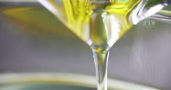 Transparent clear yellow oil is poured into glass 4k movie