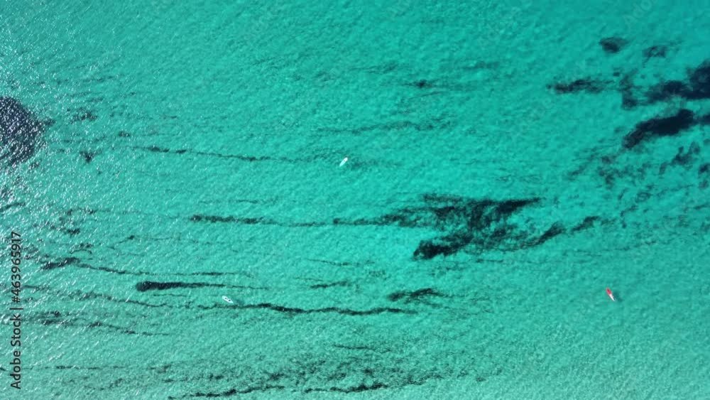 Canvas Prints An aerial view of a blue calm sea with people having a rest on the soft sand