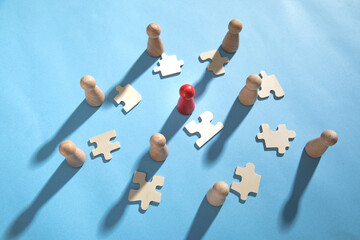 Wooden human figures with a jigsaw puzzles.