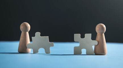 Wooden human figures with a jigsaw puzzles.