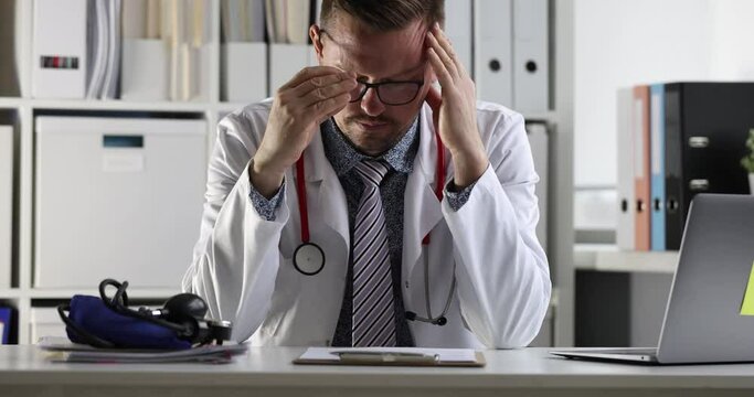 Tired doctor with headache takes off glasses at workplace 4k movie